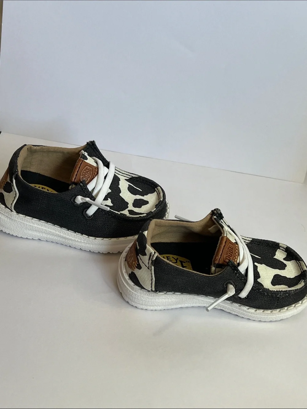 Hey Dude Wendy Black and White Cow Print Slip-On Loafers